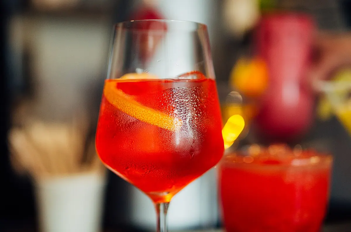 Clear ice in a bar cocktail glass with citrus