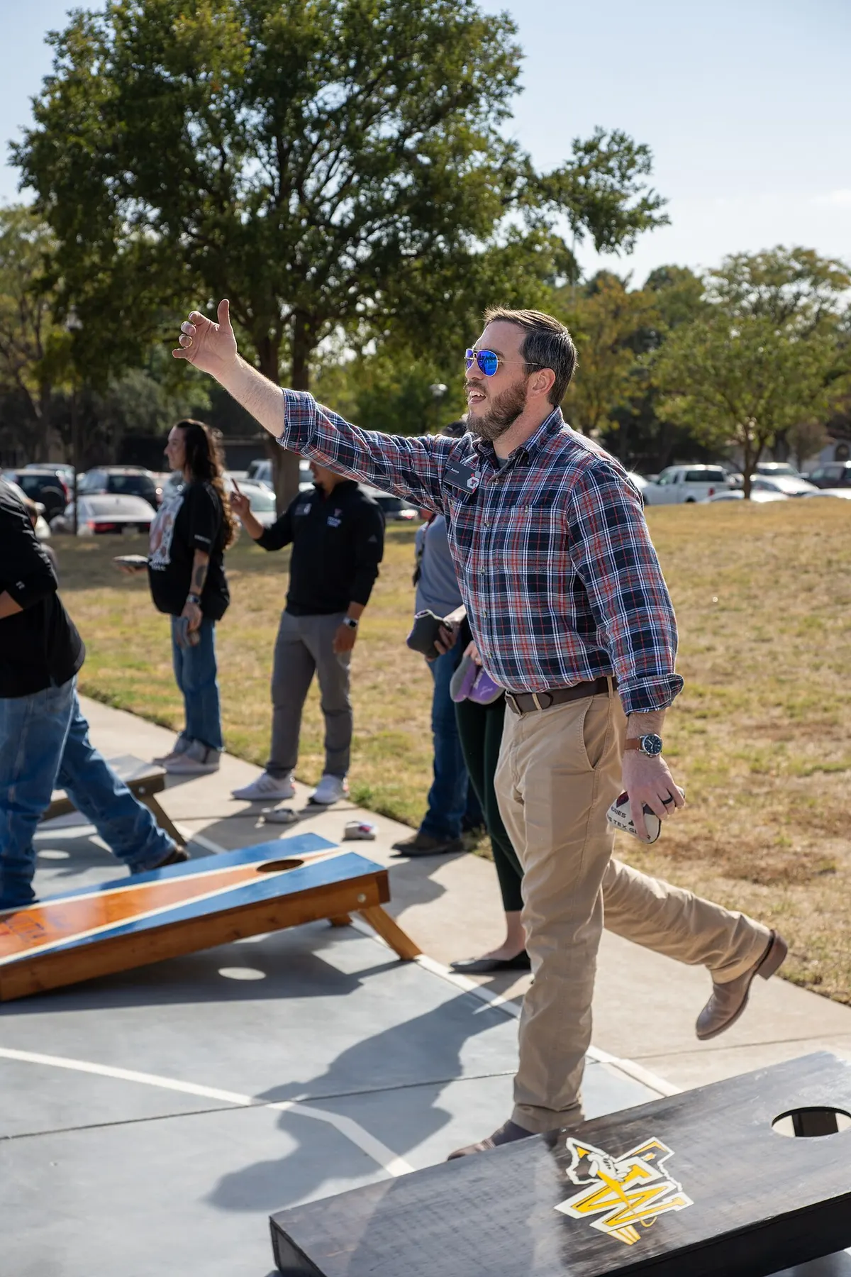 Cornhole boards set up outdoors during a backyard competition
