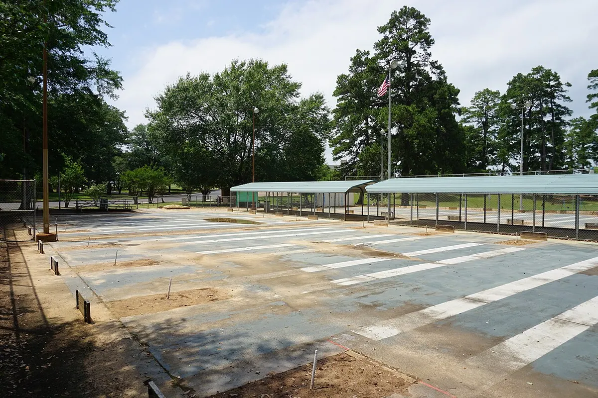 Regulation horseshoe pitching arena with parallel pits, stakes, and boxed sand courts